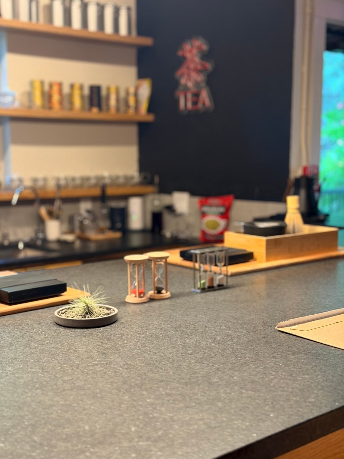 Detail of tea bar with hourglass timers and TEA logo