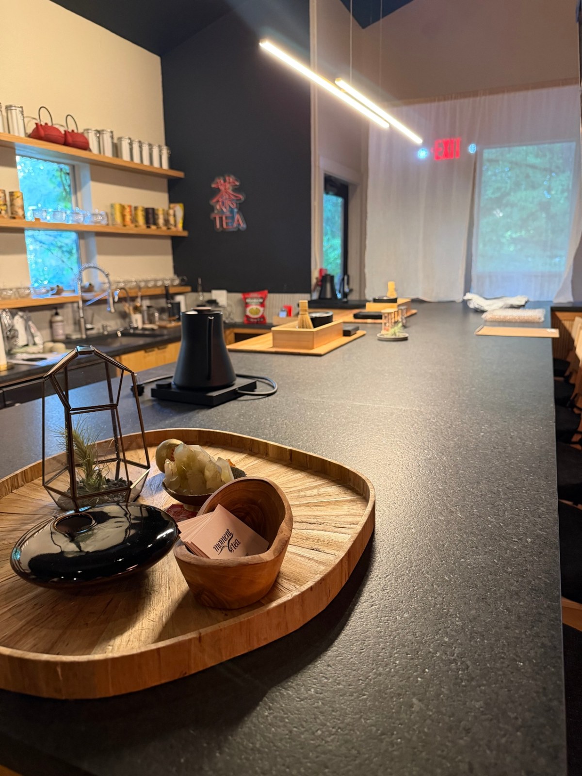 Long tea bar with kettle, matcha station, and TEA sign